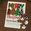 Weihnachts-Gutschein zum Puzzeln Teilweise zusammengesetztes Weihnachts-Puzzle mit Gutschein-Motiv und einzelnen Puzzleteilen
